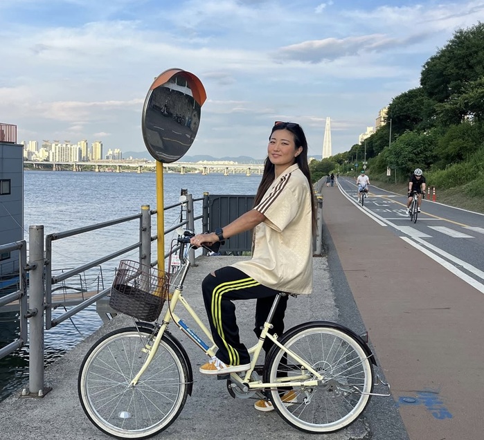 Cho So-hyun on a bicycle by the Han River